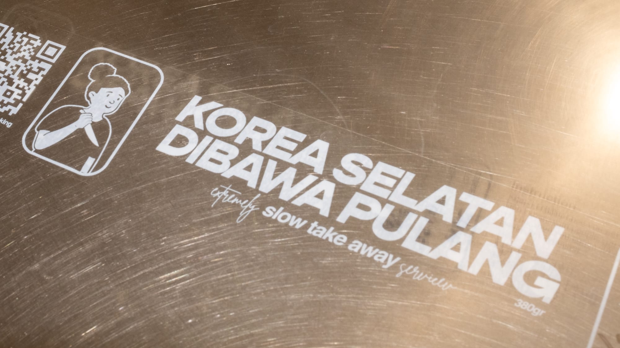Korea Selatan Dibawa Pulang branding on a metal surface.
